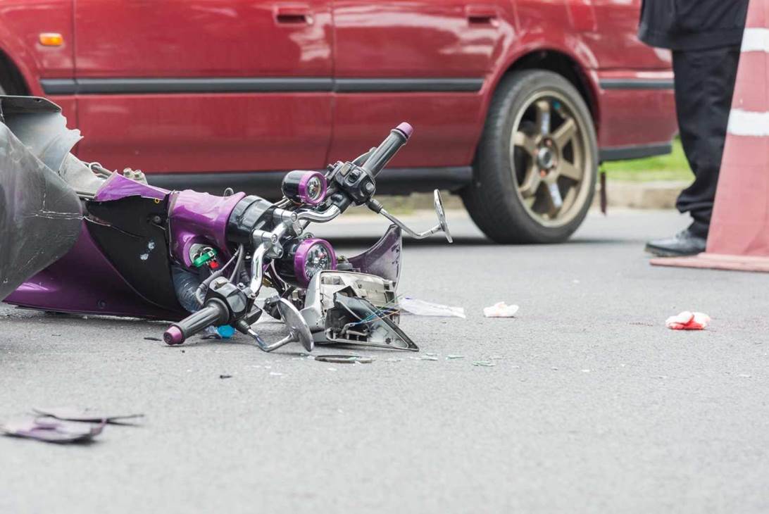 A broken motorcycle on the ground

AI-generated content may be incorrect.